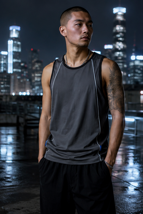 Male model wearing the graphite Afterdark panel tank on a wet city rooftop