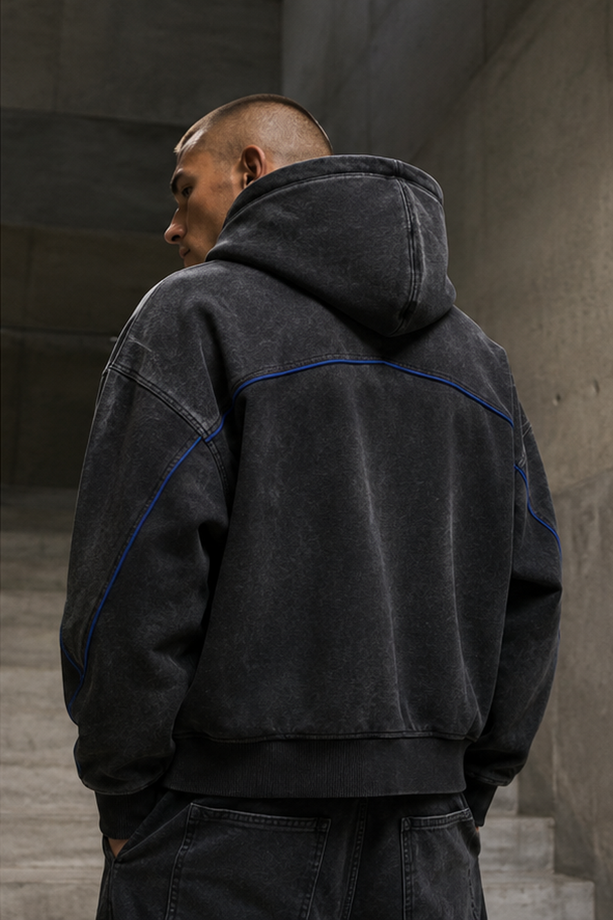 Back and hood detail of the District Zero oversized hoodie in washed black
