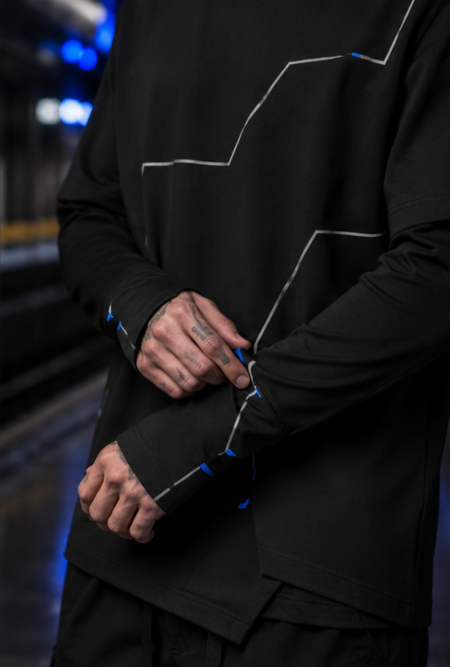 Sleeve and hem detail of the Night Transit top with silver geometric linework